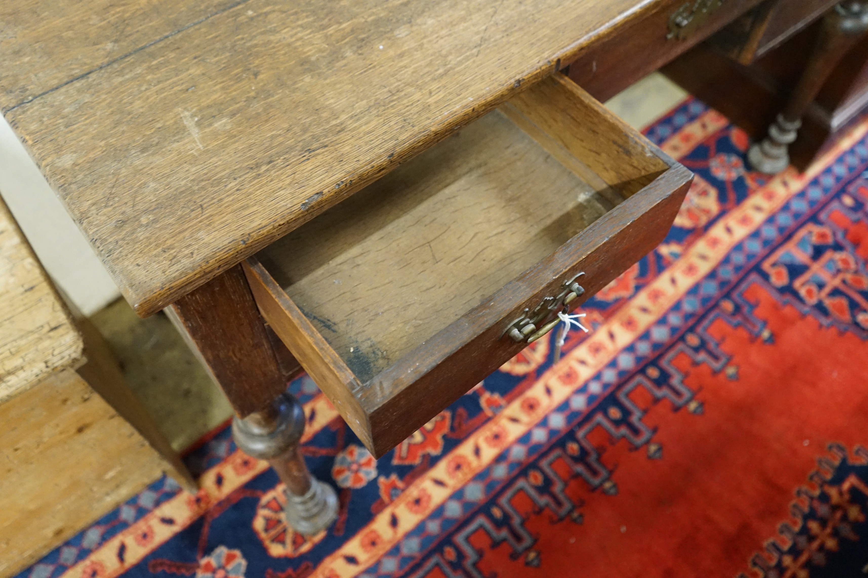 A 1920's oak kneehole desk, length 122cm, 61cm, height 76cm